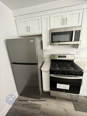 Hawthorne apartment for rent - a kitchen with white cabinets and stainless steel appliances